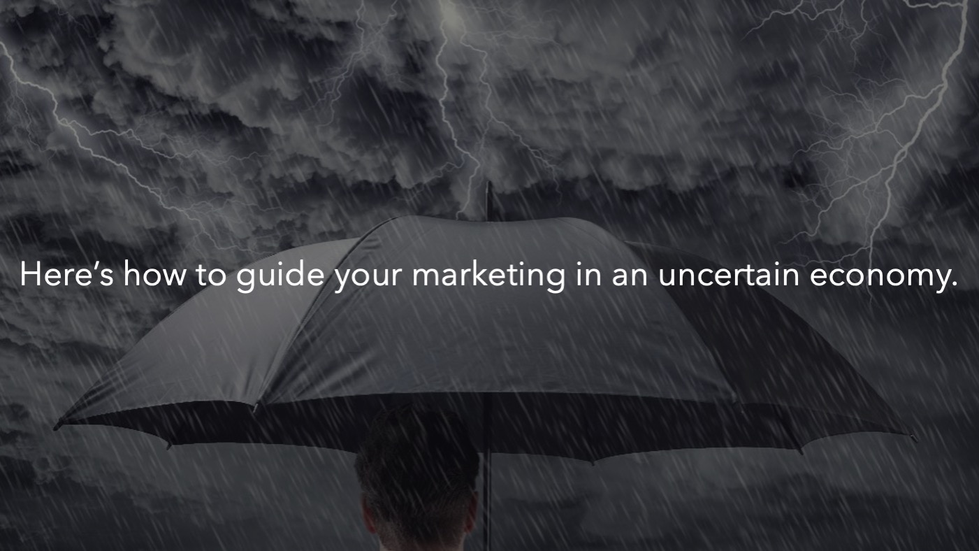 A gray and stormy scene with an umbrella and a text overlay saying - Here's how to navigate your marketing in an uncertain economy.