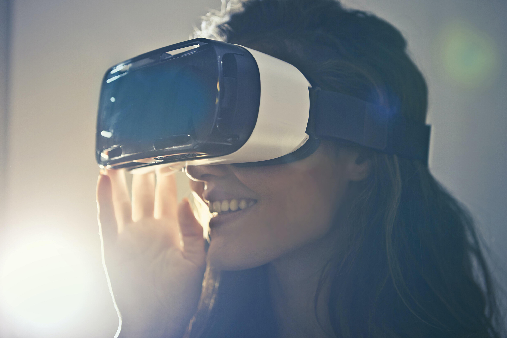 Woman backlit with a VR headset