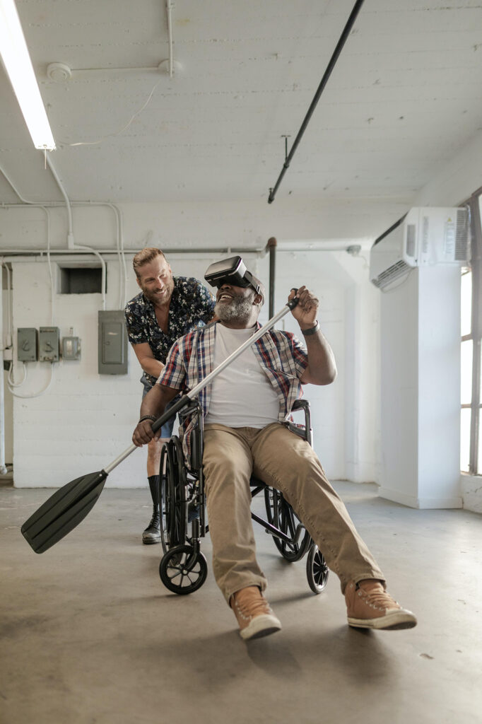 Man in a wheelchair rowing with a VR headset on